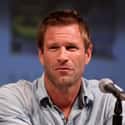 The Dark Knight, Olympus Has Fallen, Battle Los Angeles   Aaron Edward Eckhart is an American film and stage actor. Born in California, he moved to England at the age of 13, when his father relocated the family.