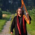 New Age, World music, Classical music   Andreas Vollenweider is a Swiss harpist, who is generally categorised as New Age and uses a modified, electroacoustic harp of his own design.