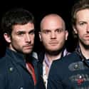 Rock music, Piano rock, Post-Britpop   Coldplay are a British rock band formed in 1996 by lead vocalist Chris Martin and lead guitarist Jonny Buckland at University College London.