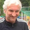age 58   Rudolf "Rudi" Völler is a former German international footballer, and a former manager of the German national team. He won the FIFA World Cup in 1990 as a player.