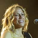 age 57   Sheryl Suzanne Crow is an American singer, songwriter, and guitarist. Her music incorporates elements of pop, rock, folk, country and blues.