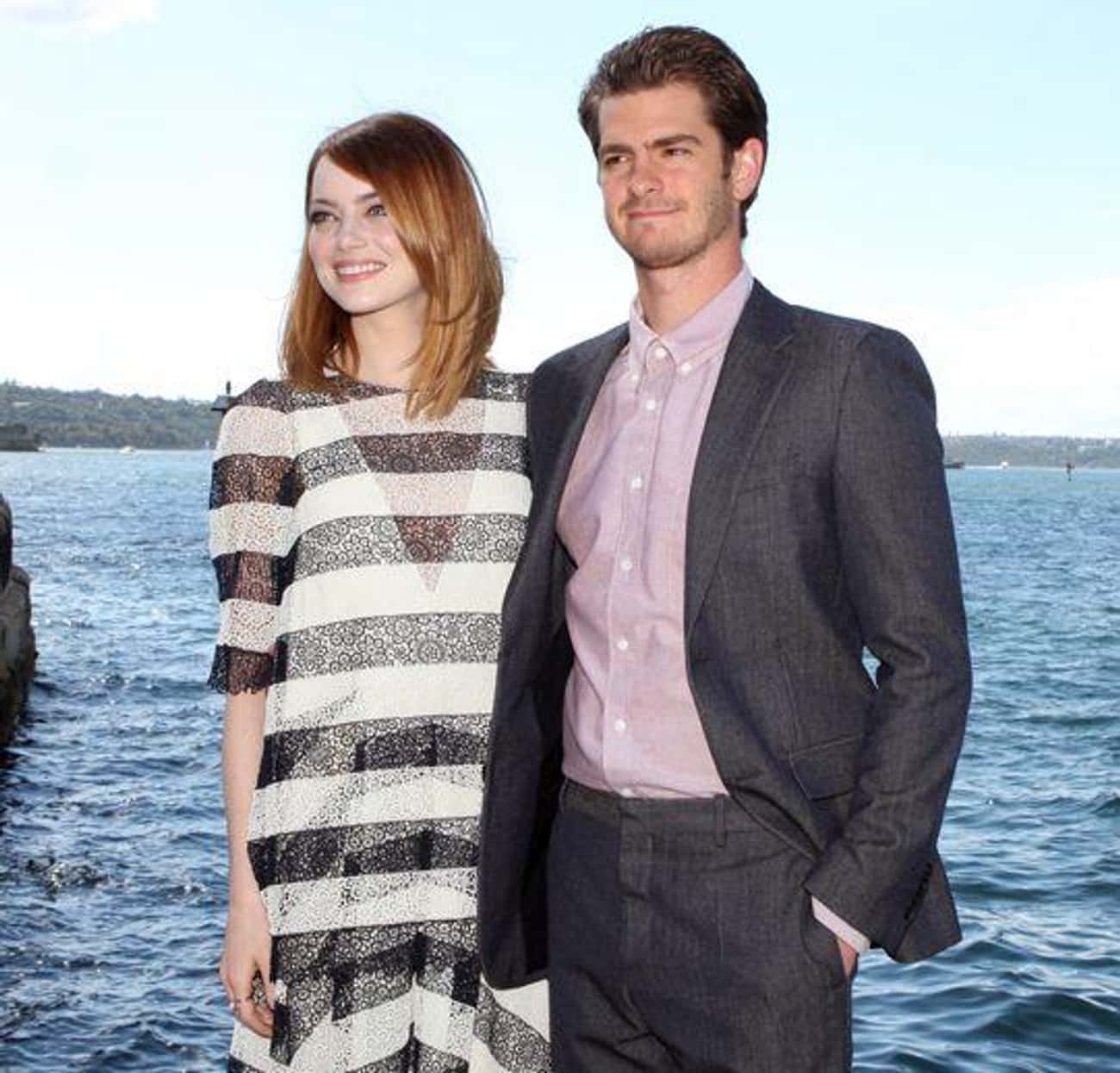 Emma Stone And Andrew Garfield Hold Up Signs Promoting Charities