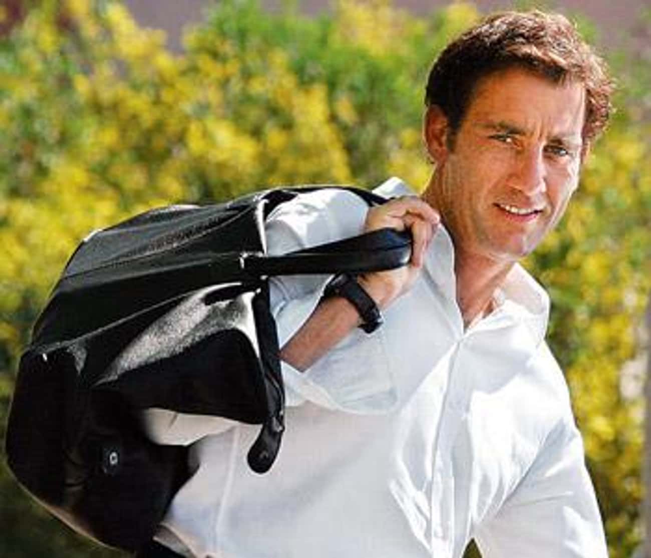 Clive Owen in White Long Sleeves and Designer Bag