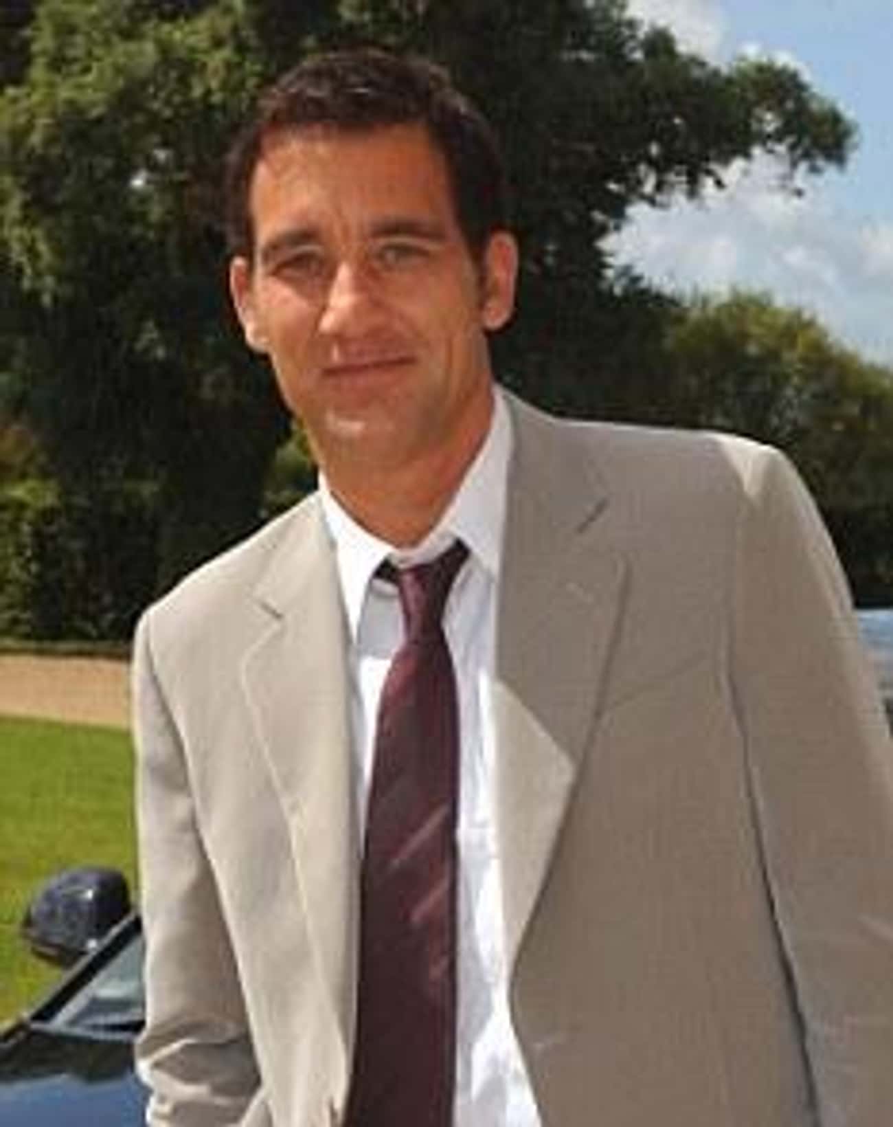 Clive Owen in Grayish Tan Coat and Brown Neckie