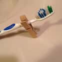 Use Clothespins to Prevent Toothbrush from Touching Gross Counters on Random Tips and Tricks That'll Change the Way You Travel