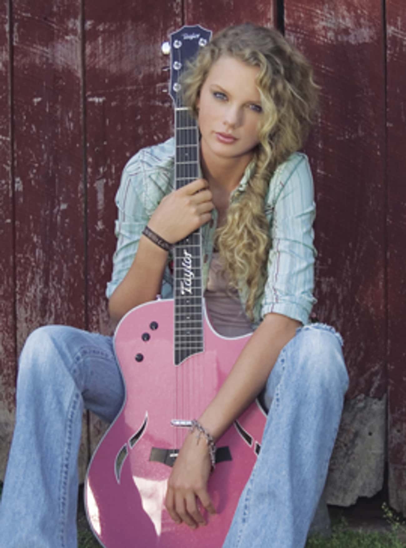 Young Taylor Swift Holding a Pink Guitar