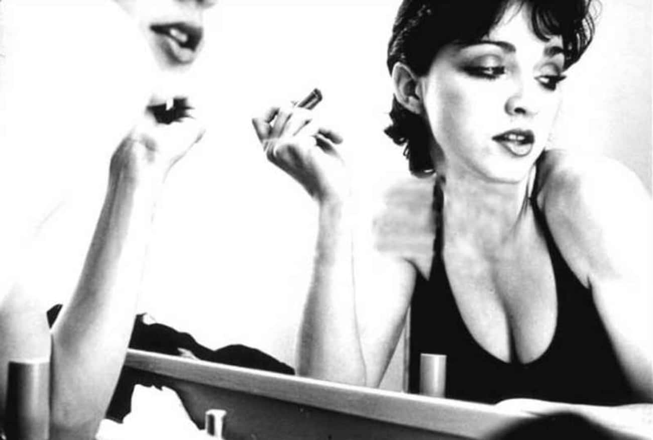 Young Madonna Putting Lipstick On