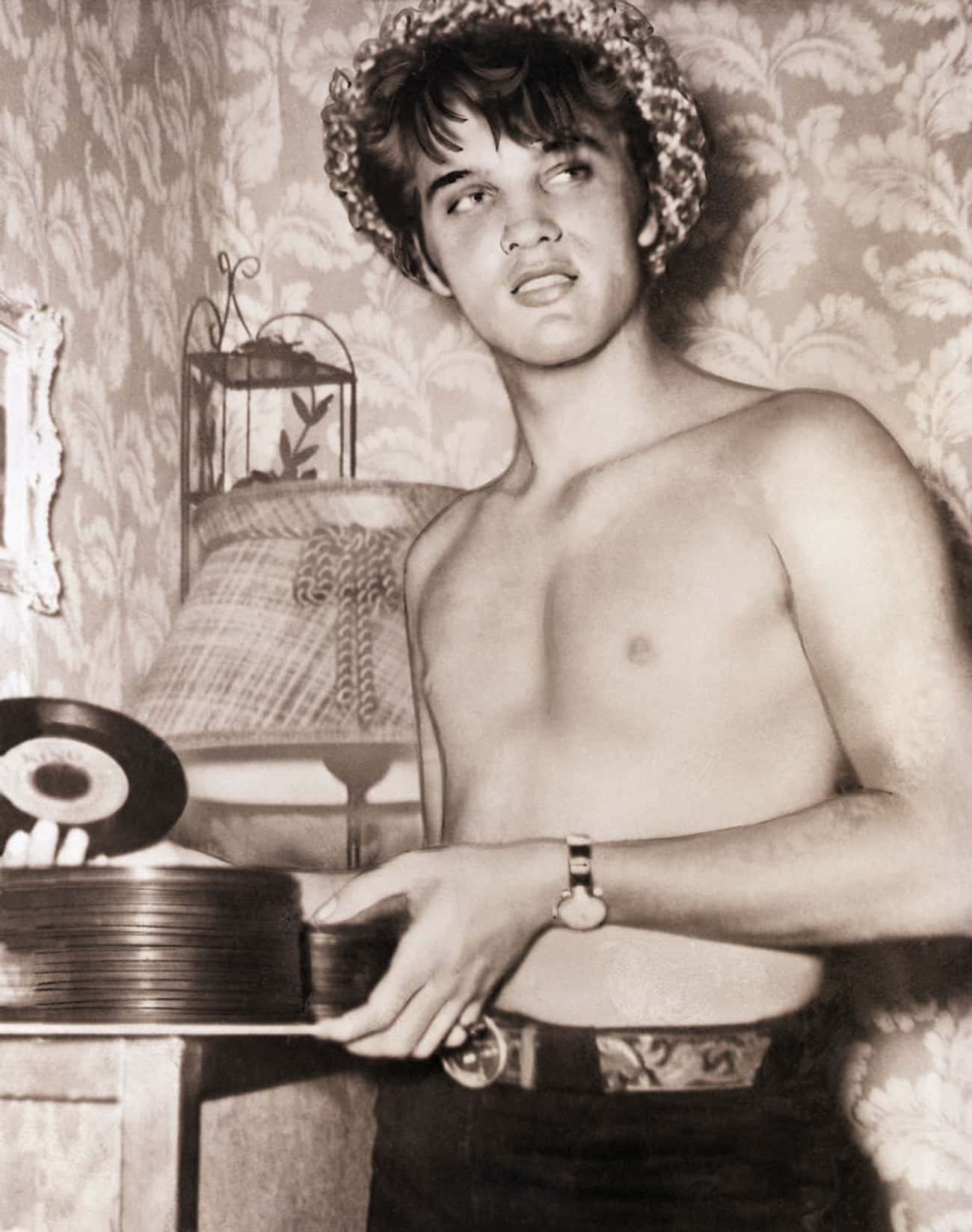 Young Elvis Presley Holding Records Shirtless