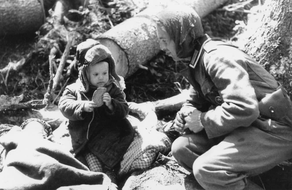 A German Soldier Sharing Bread is listed (or ranked) 12 on the list 36 Rare Photos From World War II