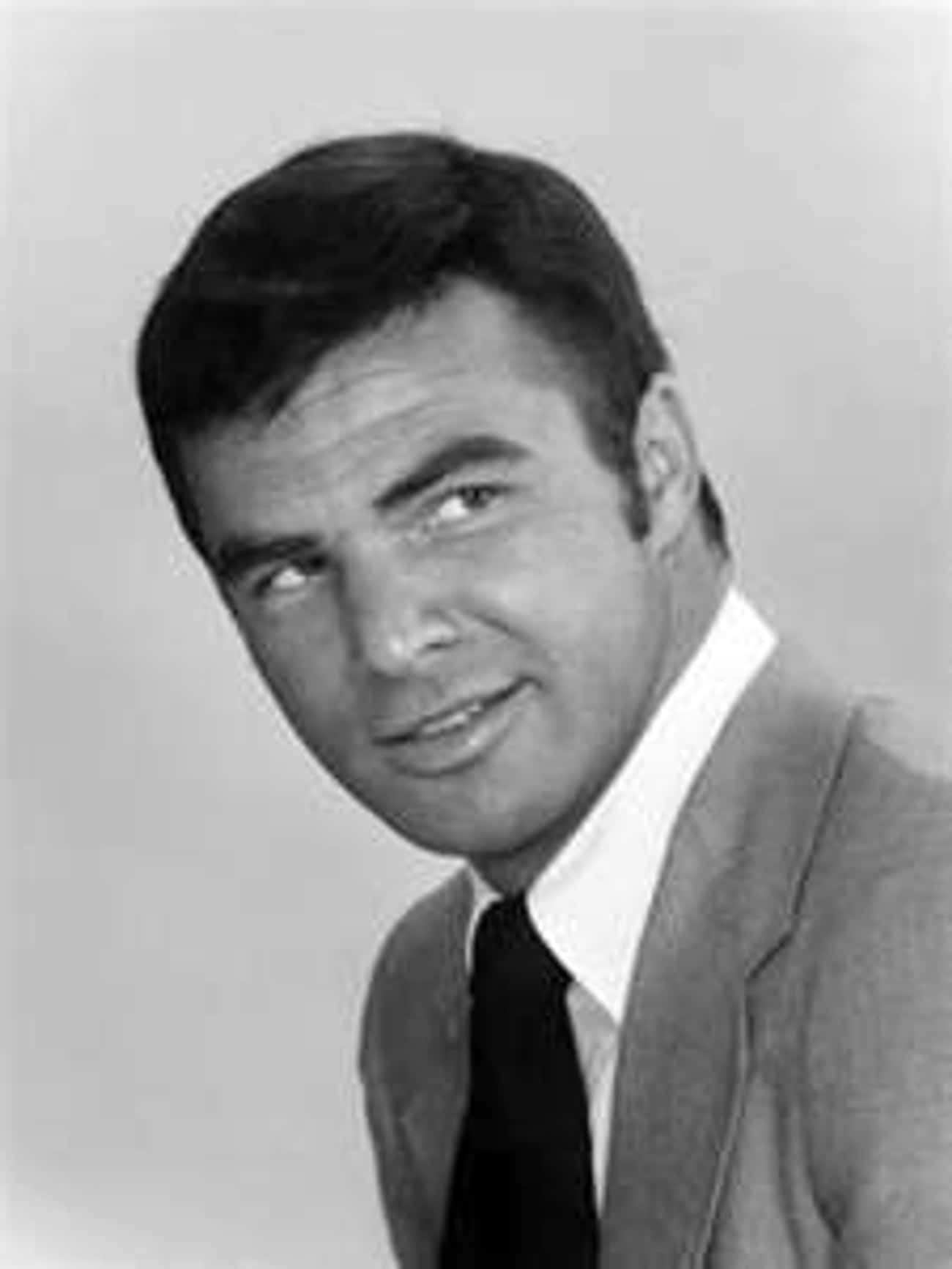 Young Burt Reynolds in a Gray Suit and Black Tie
