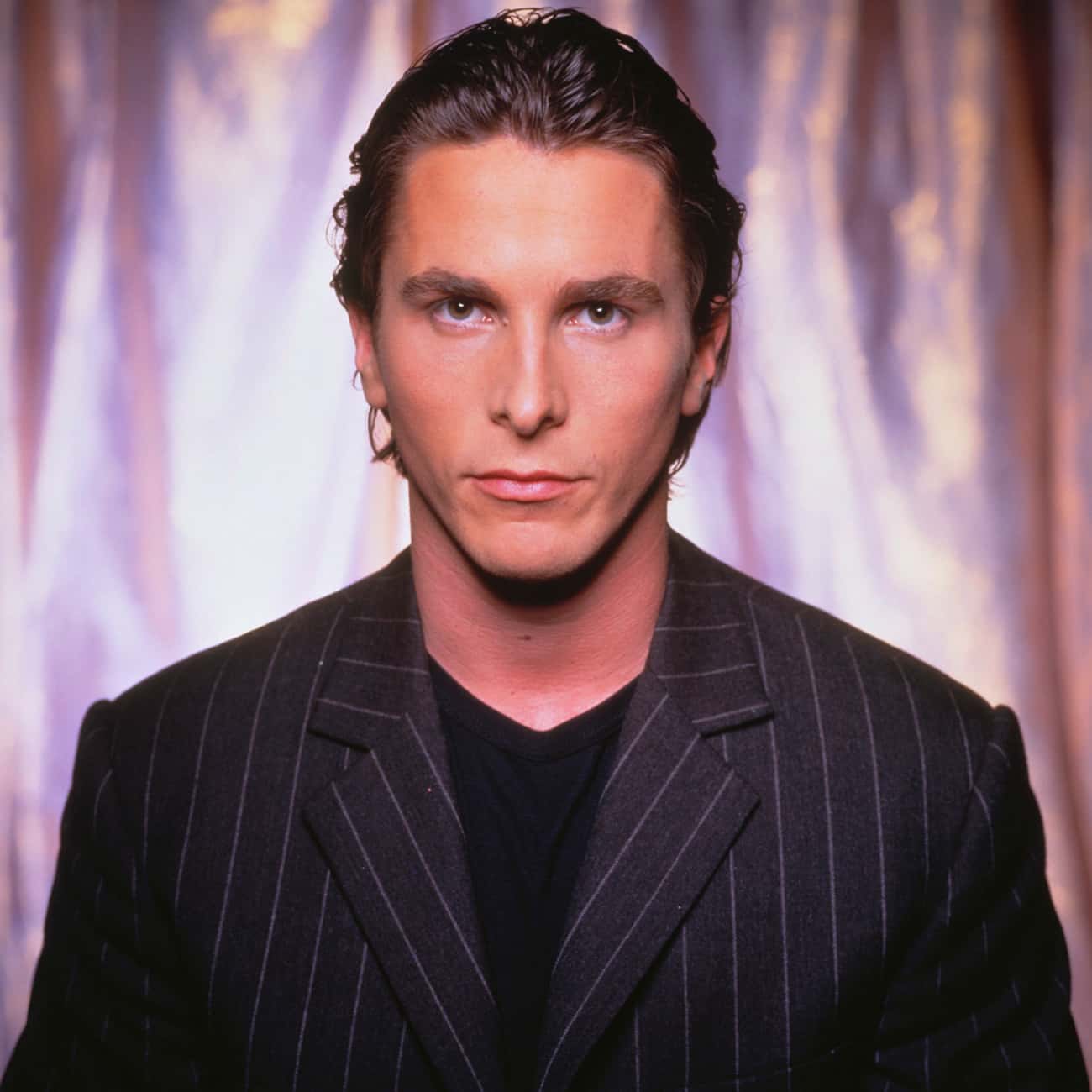 Young Christian Bale in Pinstripe Suit and Black T-Shirt