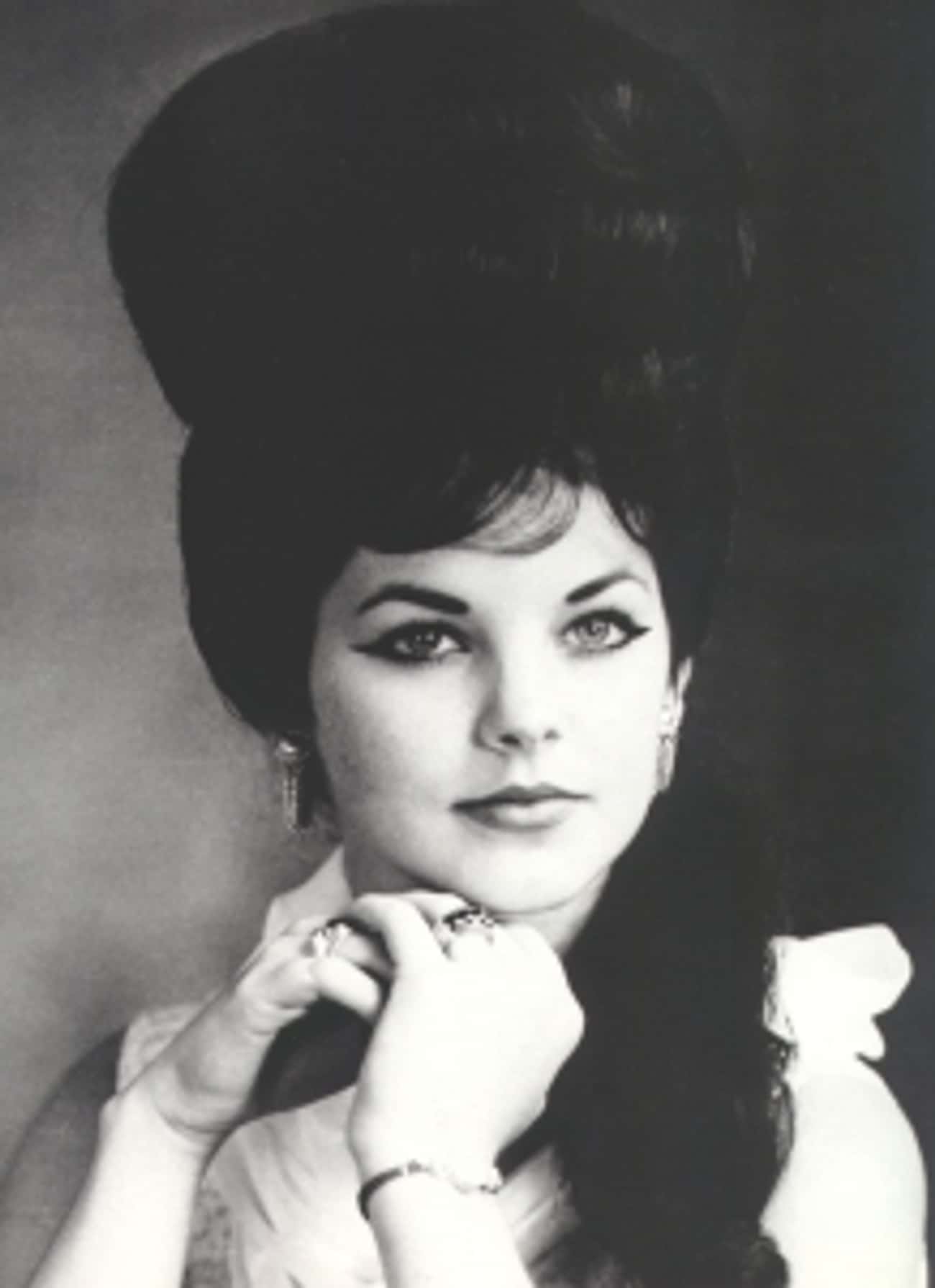 Young Priscilla Presley in a White Blouse with a Beehive