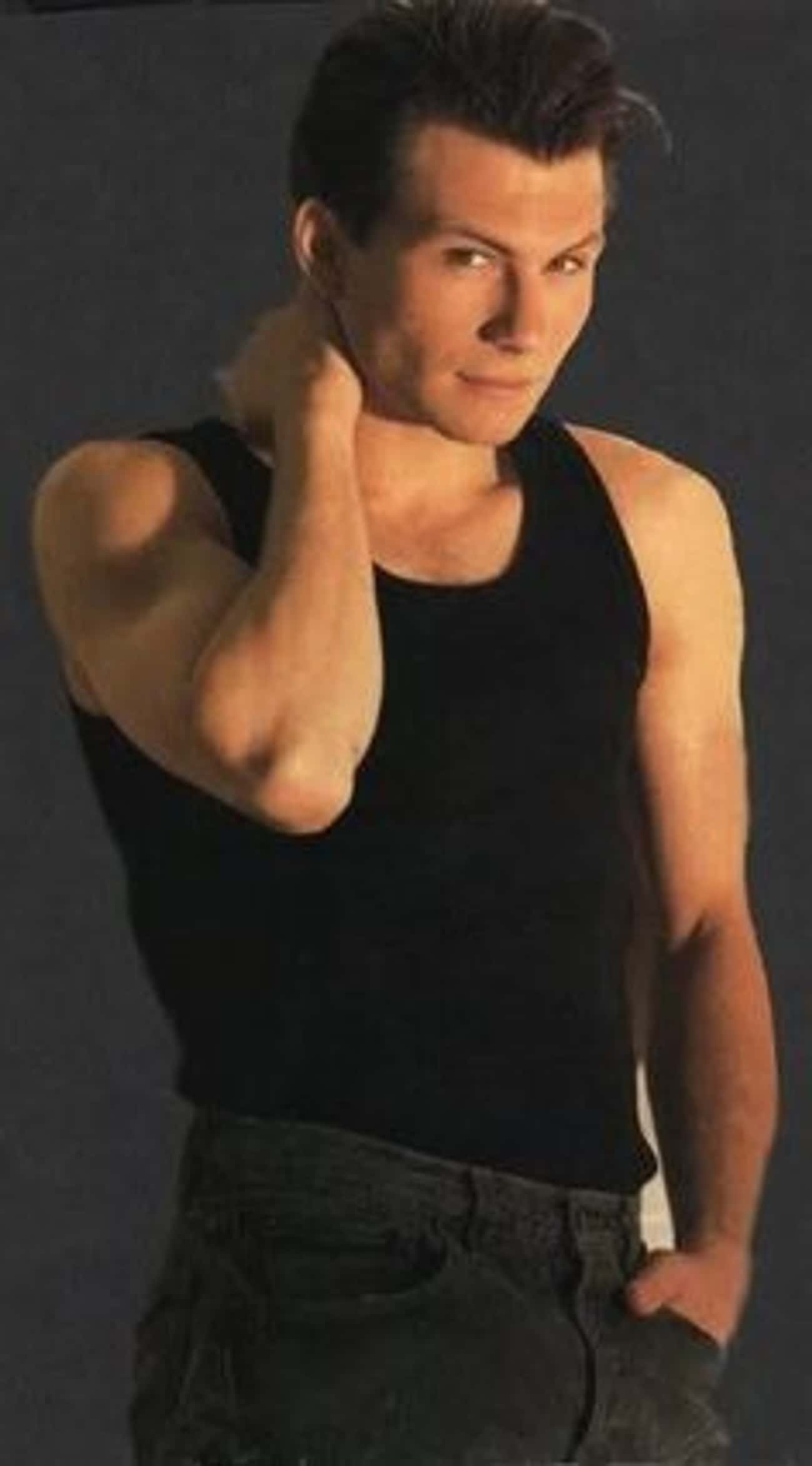 Young Christian Slater in Black Tank Top and Gray Jeans