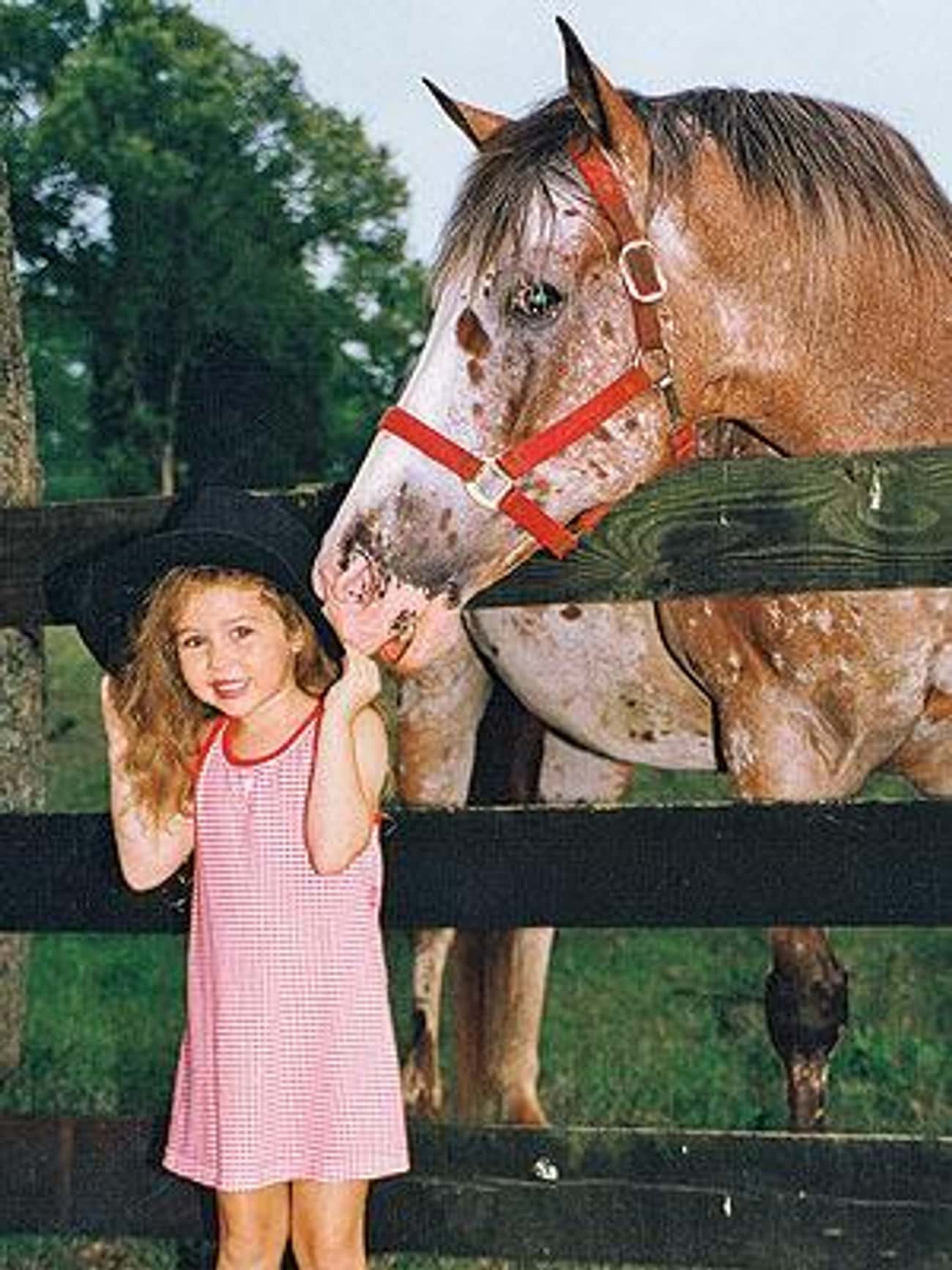 Young Miley Cyrus with a Horse