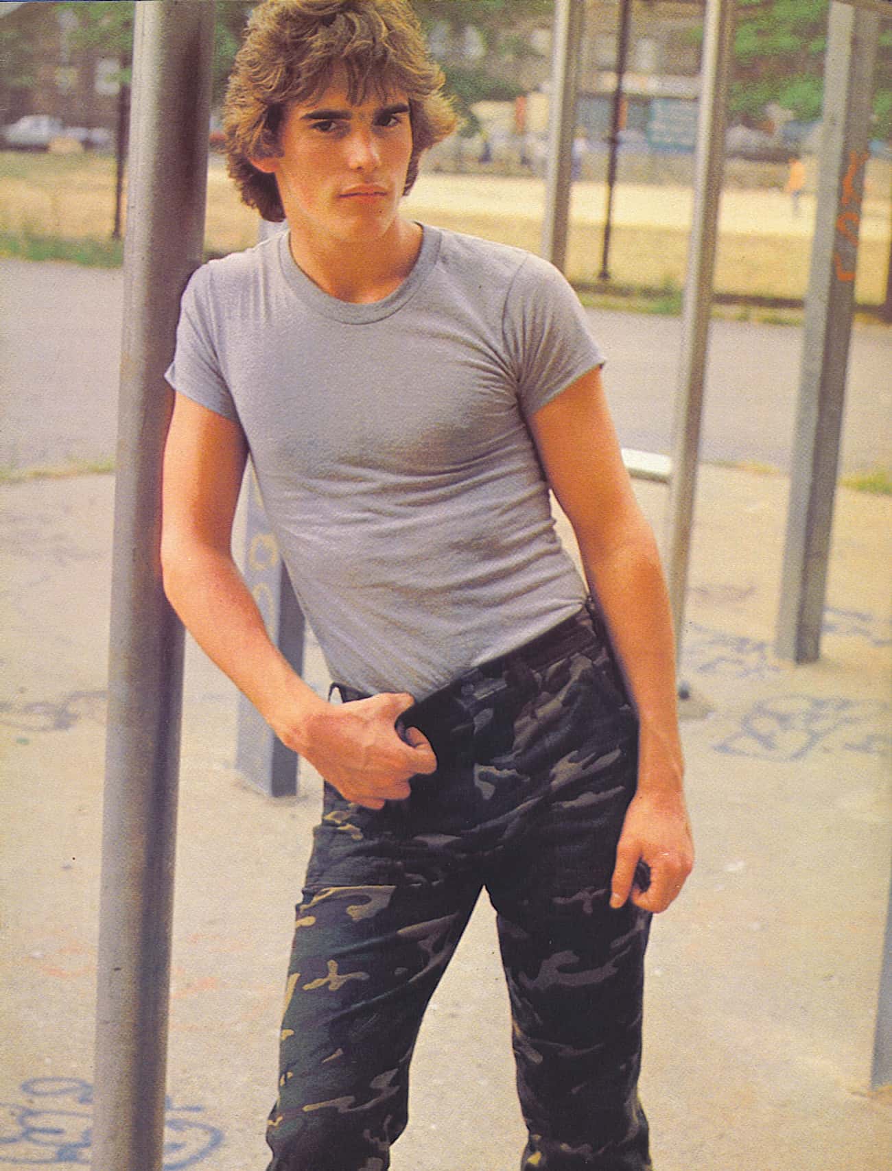 Young Matt Dillon in Dark Camo Pants and Fitted Gray Shirt