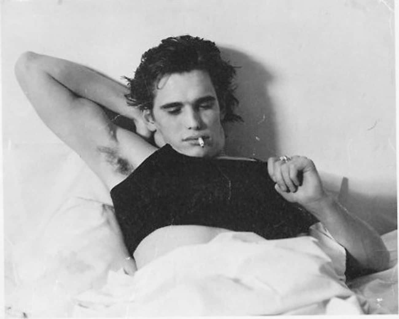 Young Matt Dillon in Black Shirt Lying Down in Bed