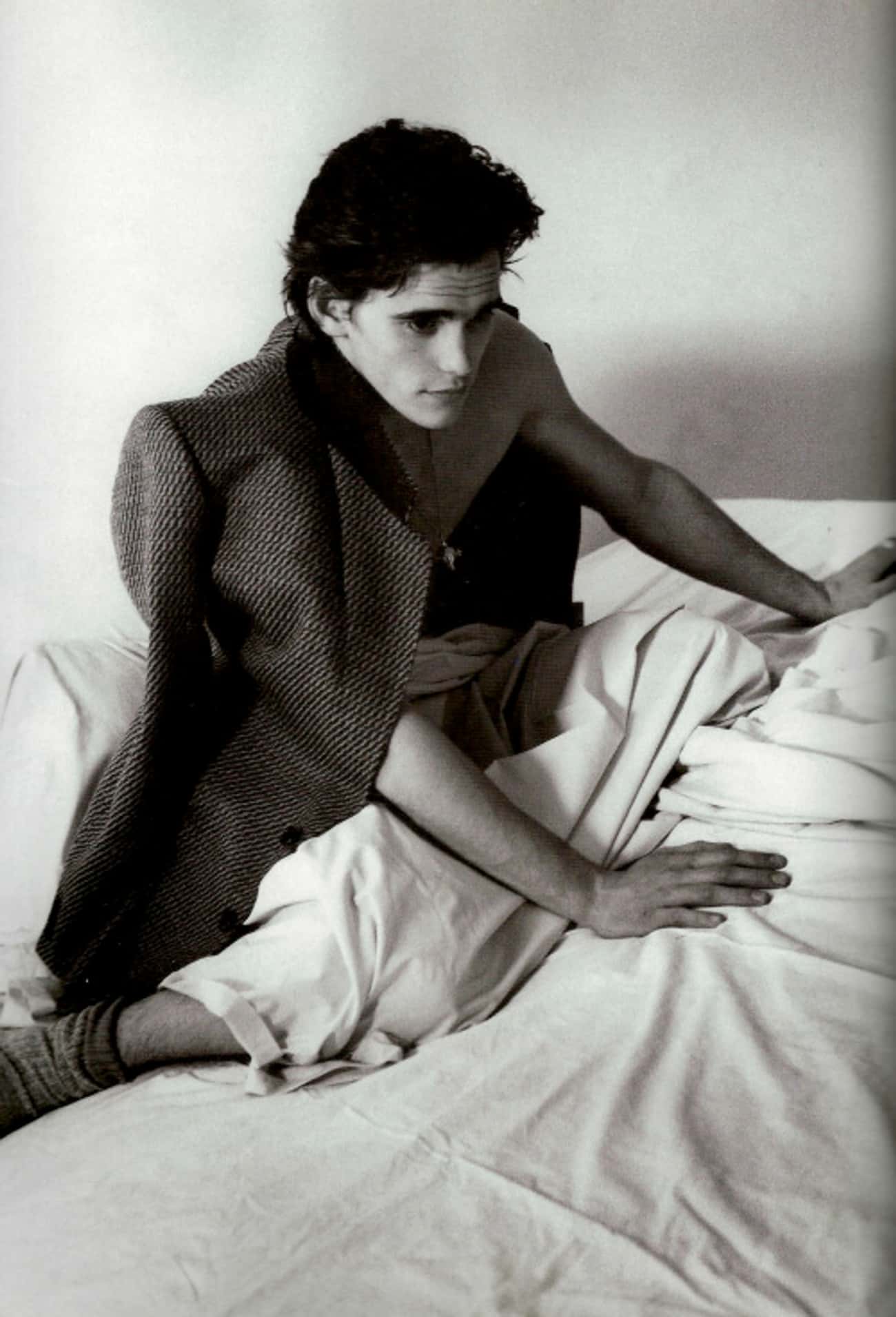 Young Matt Dillon Sitting in Bed with Sports Coat over Shoulder