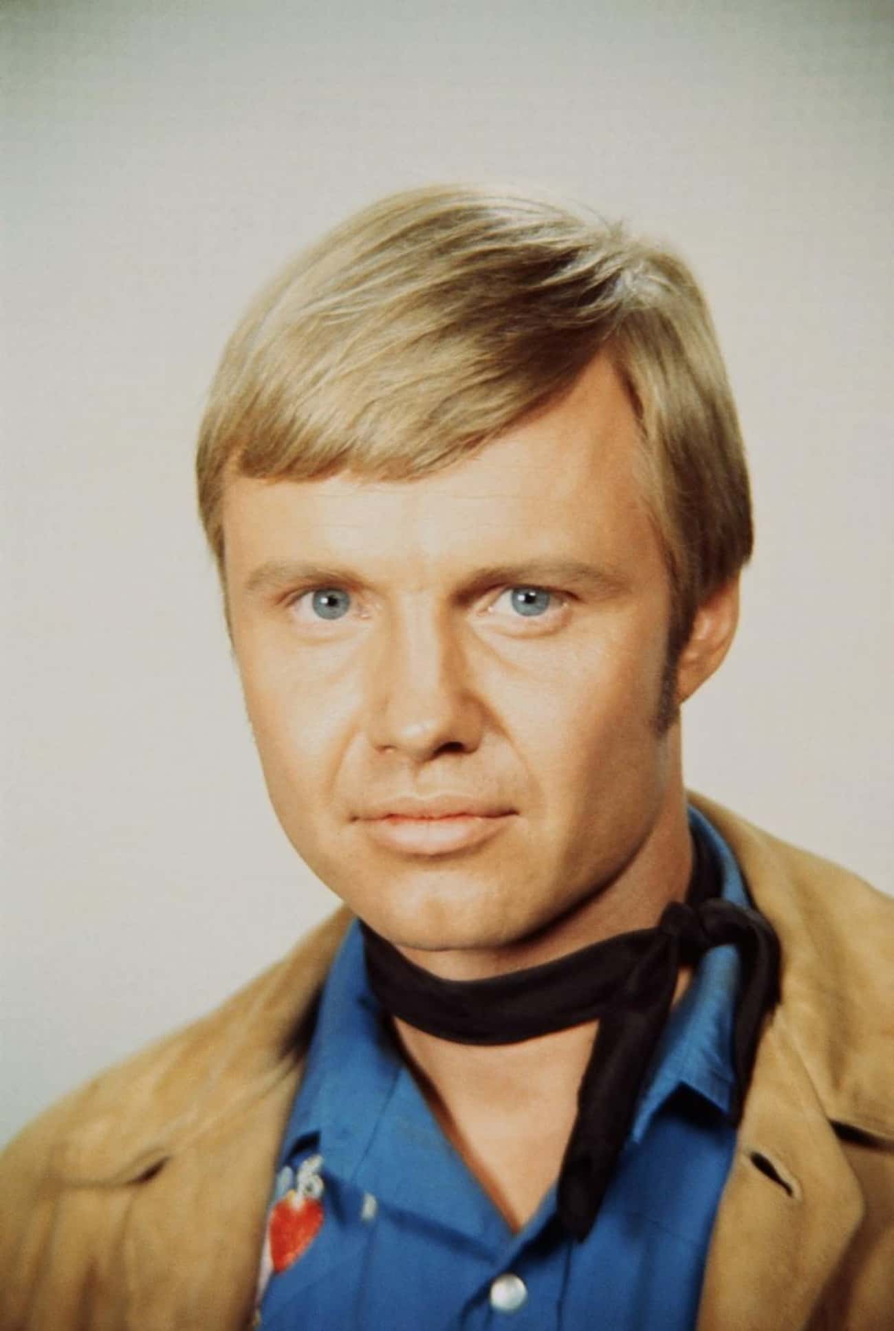 Young Jon Voight in Beige Coat and Blue Buttondown Shirt