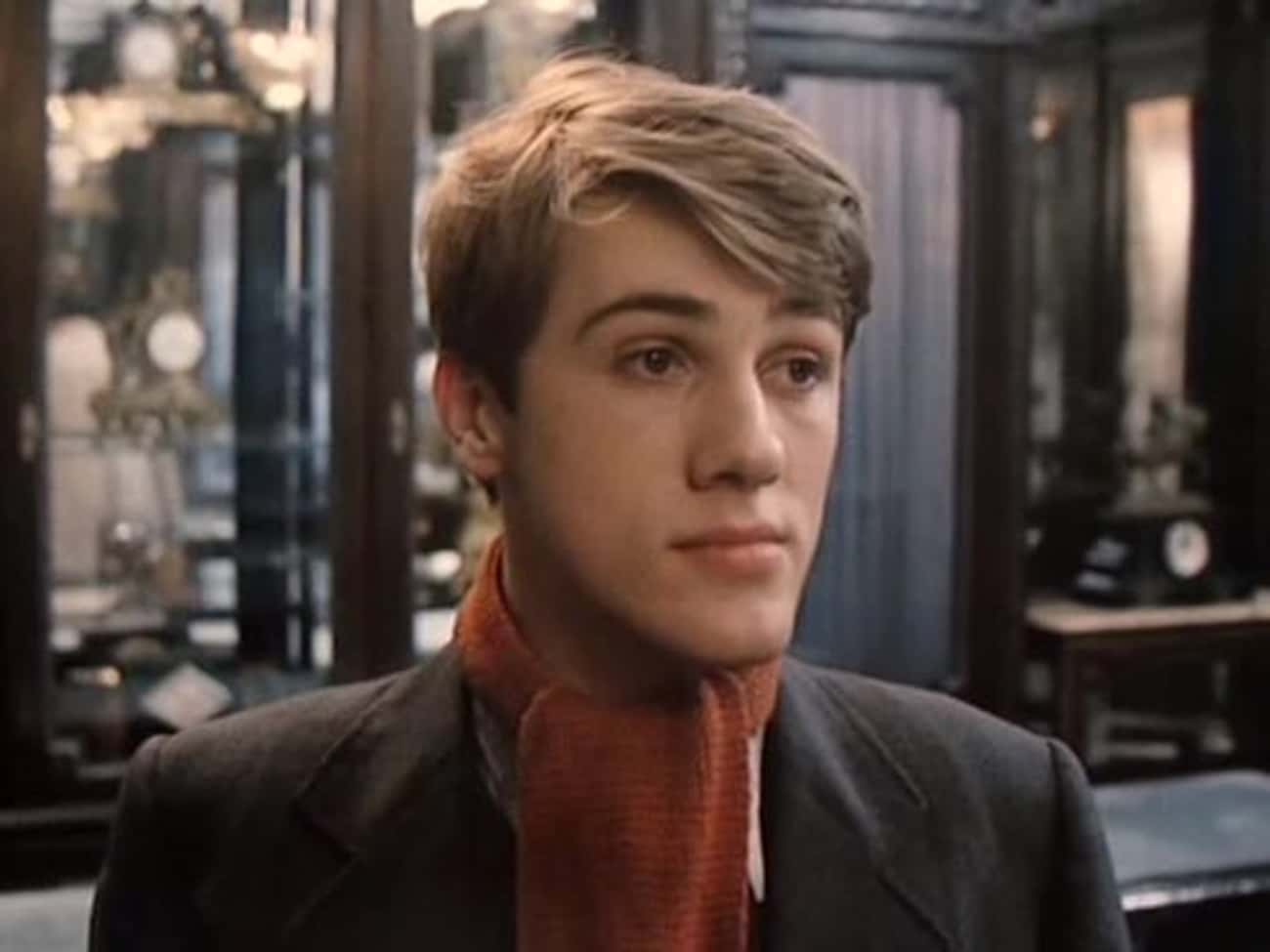 Young Christoph Waltz in Gray Coat and Orange Scarf