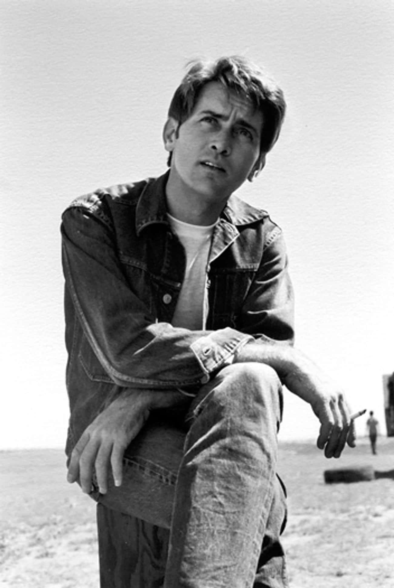 Young Martin Sheen Sitting on Tree Stump