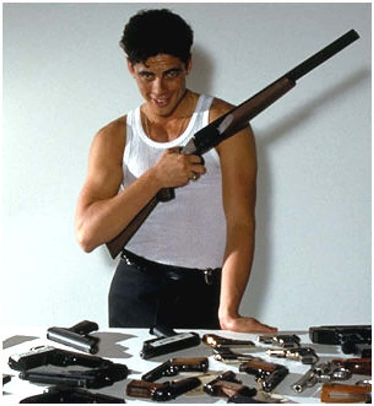 Young Benicio Del Toro in White Tank Top with Guns