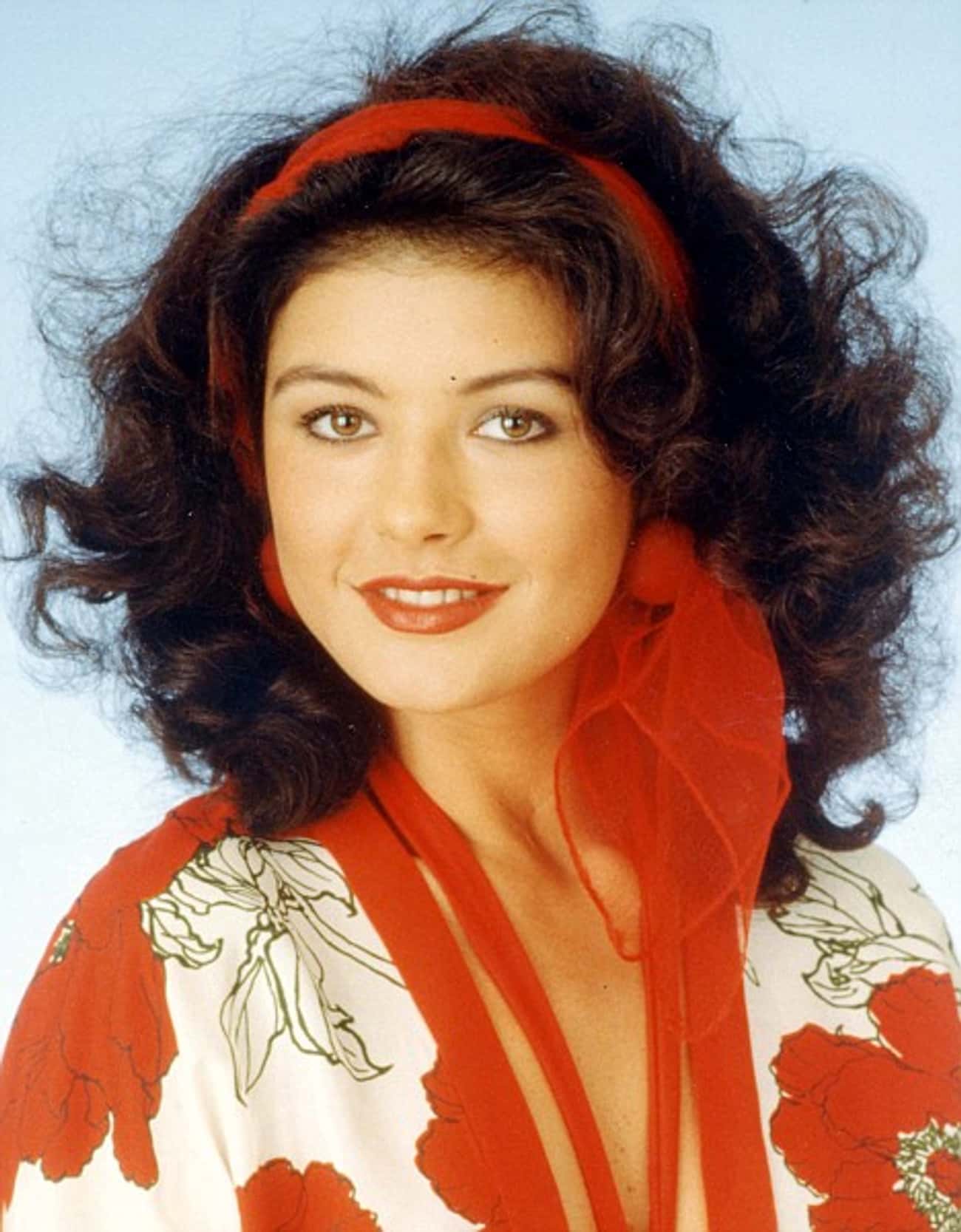 Young Catherine Zeta-Jones in Orange and White Patterned Blouse