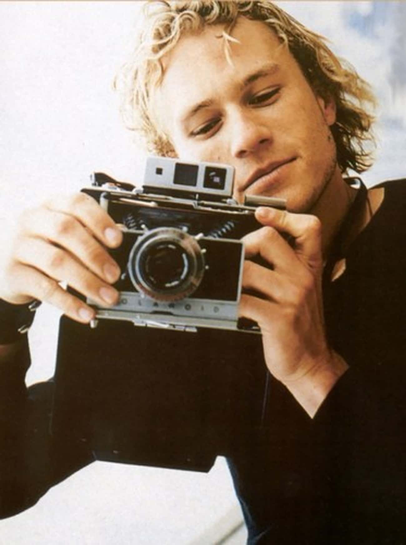 Young Heath Ledger in Black Shirt Holding Camera