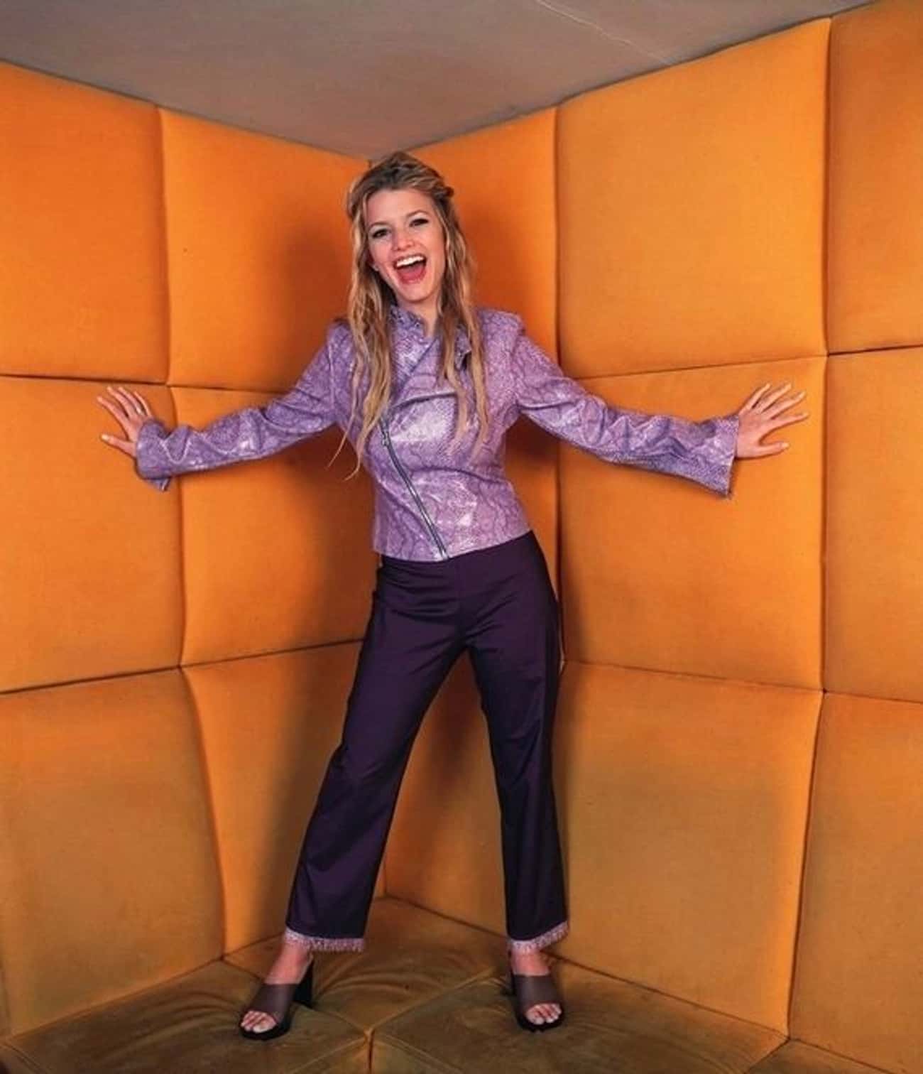 Young Jessica Simpson in Purple Leather Jacket and Purple Pants