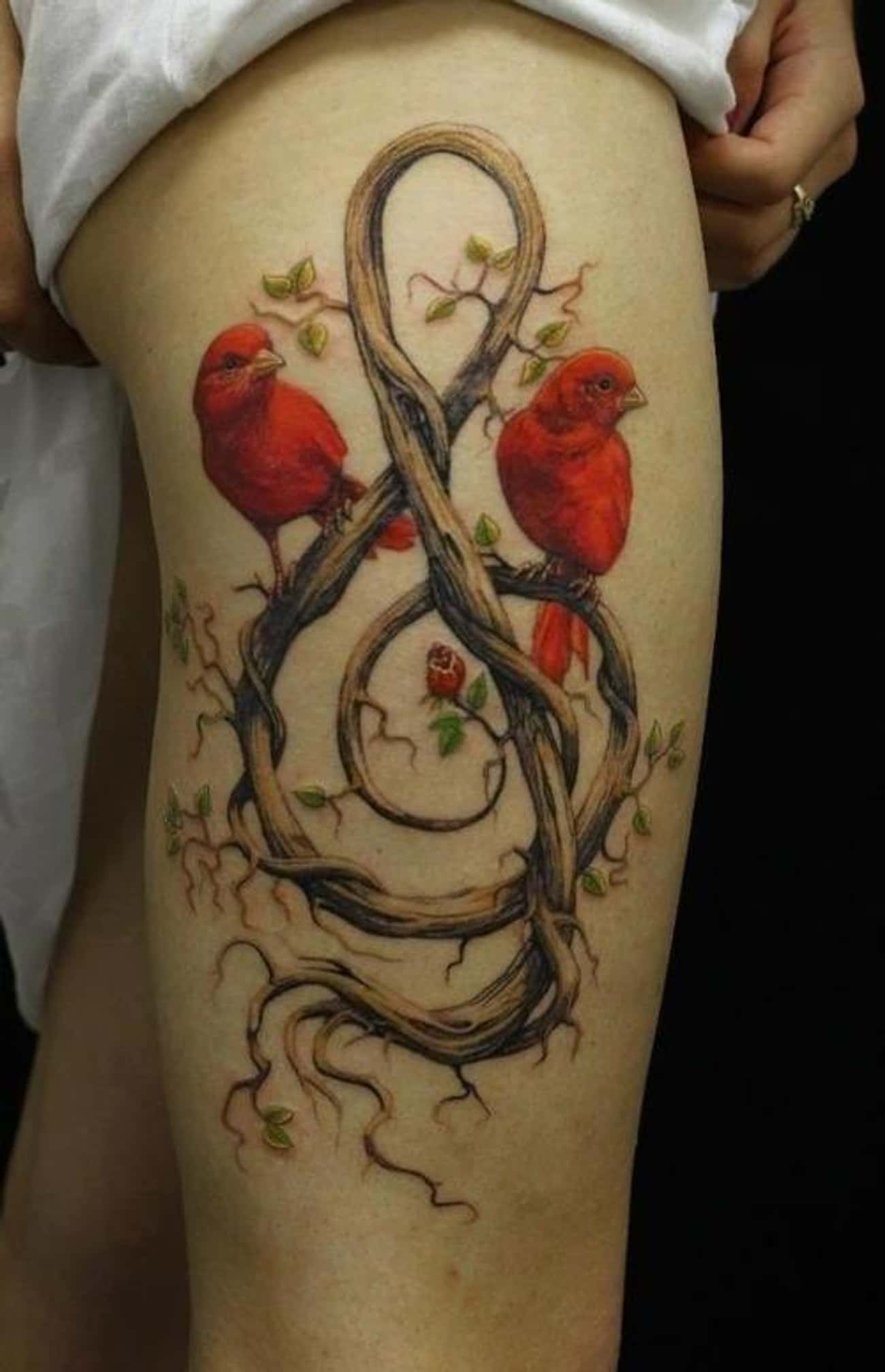 This Intricate Tattoo of Love Birds on a Wooden Treble Clef