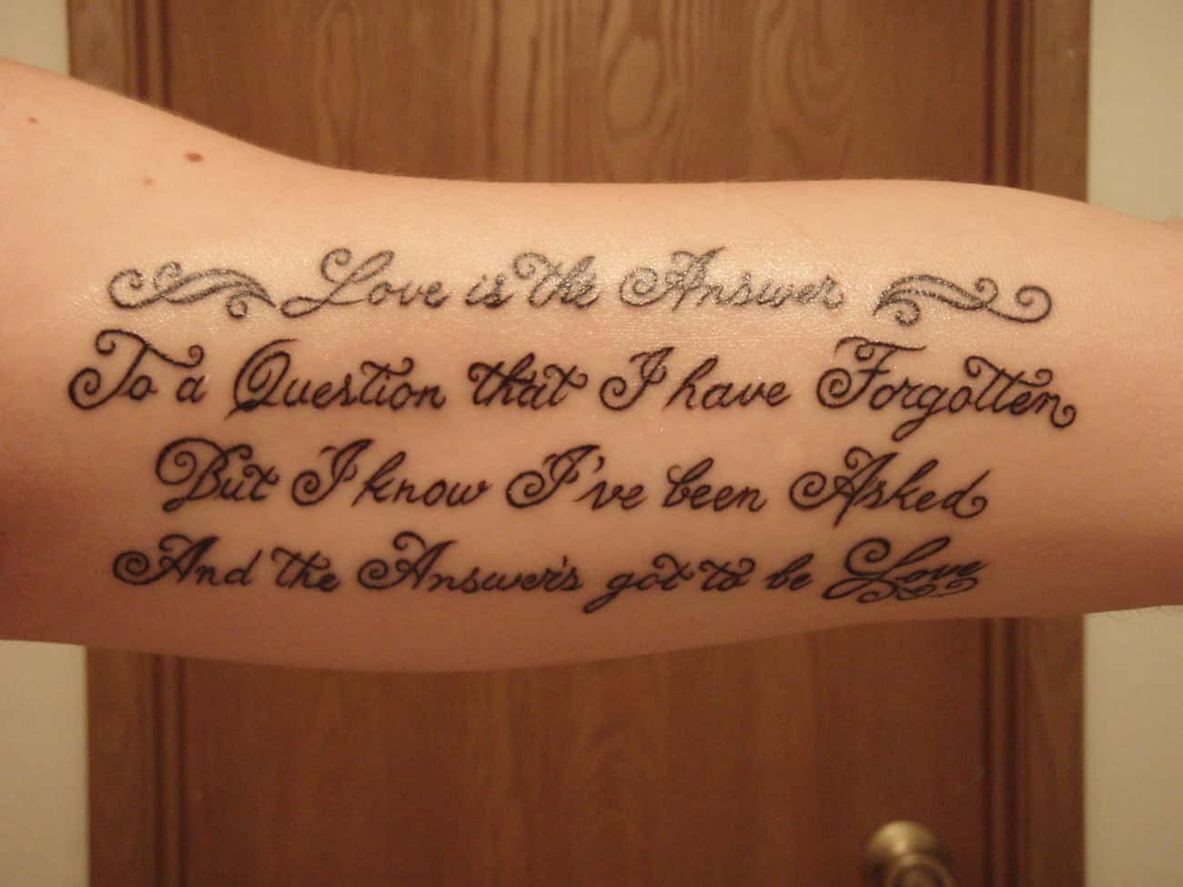 Old English Lettering Tattoo On Arm