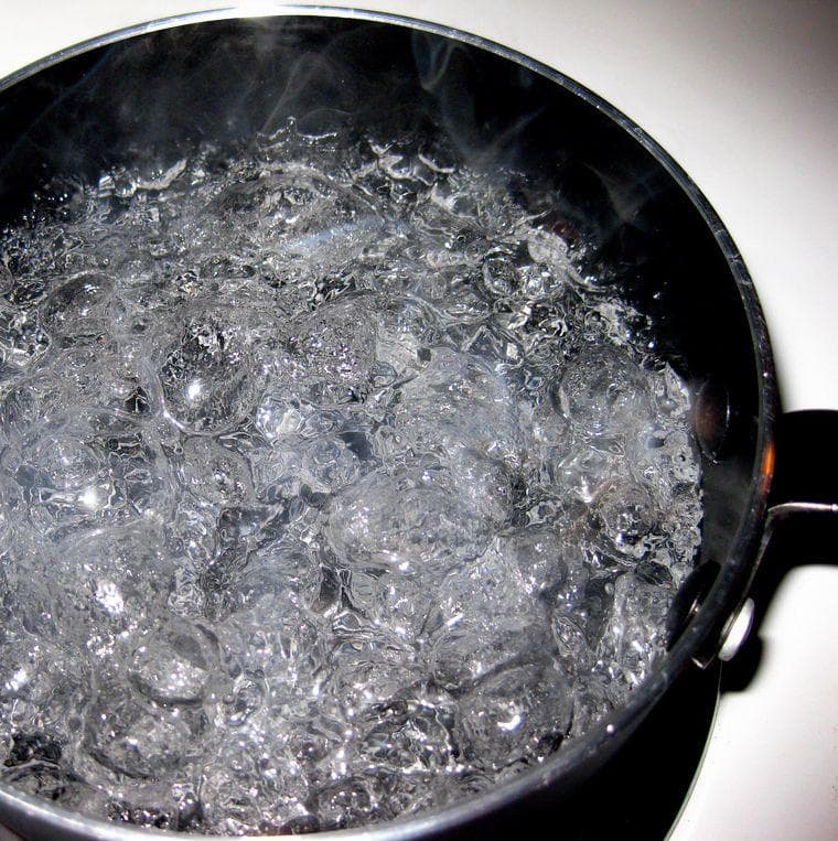 A Wooden Spoon on a Pot of Water Prevents It from Boiling Over