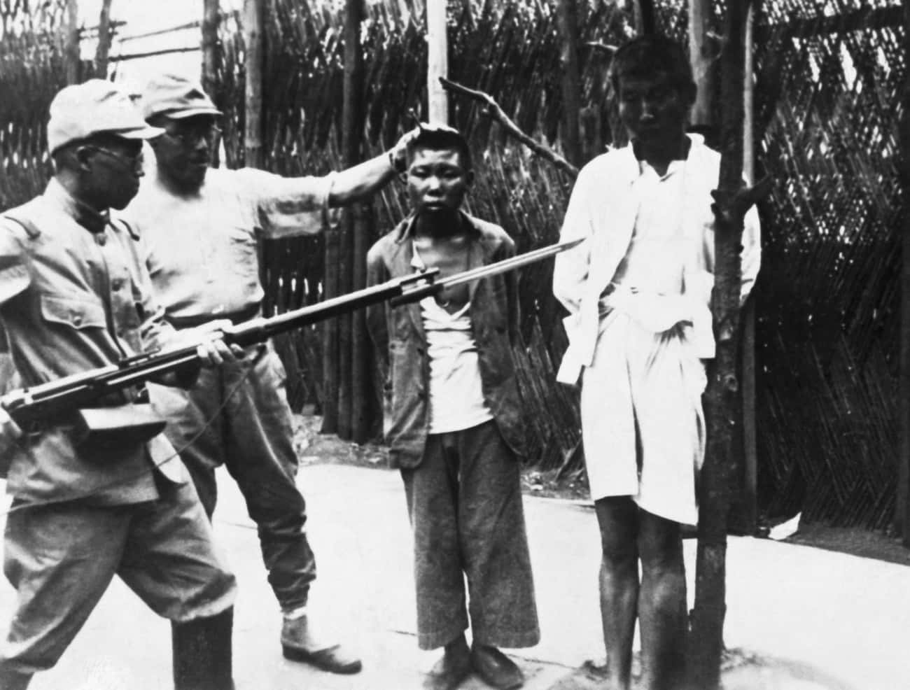 Japanese Soldiers Taunt A Pair Of Young Chinese Prisoners Before They Are Executed, 1938