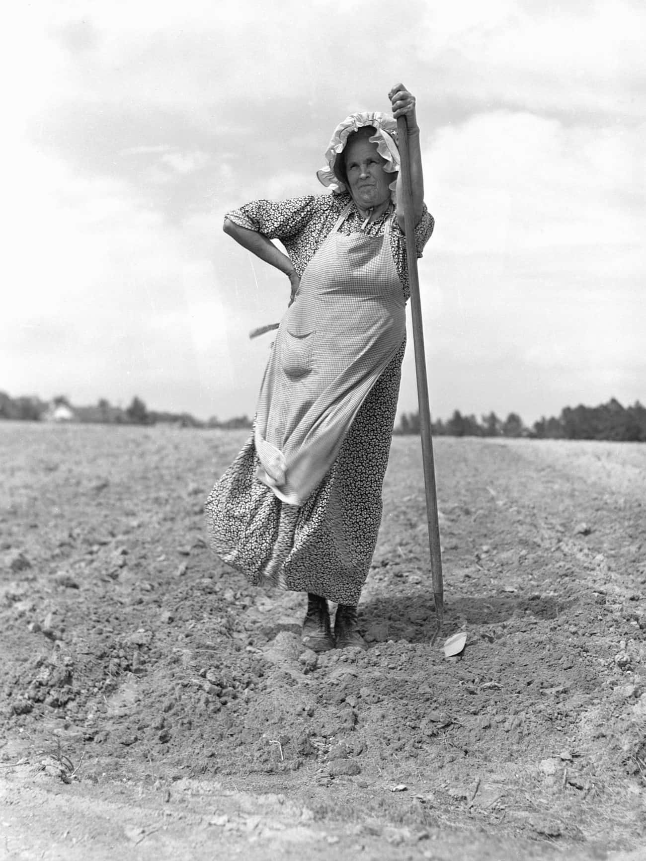 A Farm Woman Helps Her Neighbors Plant Tobacco In Durham, NC, 1940