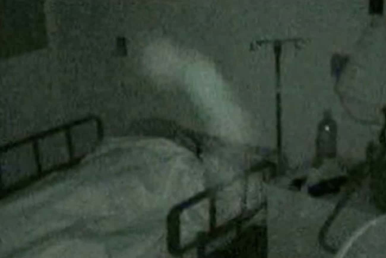 A Paranormal Entity Stands Over A Hospital Bed