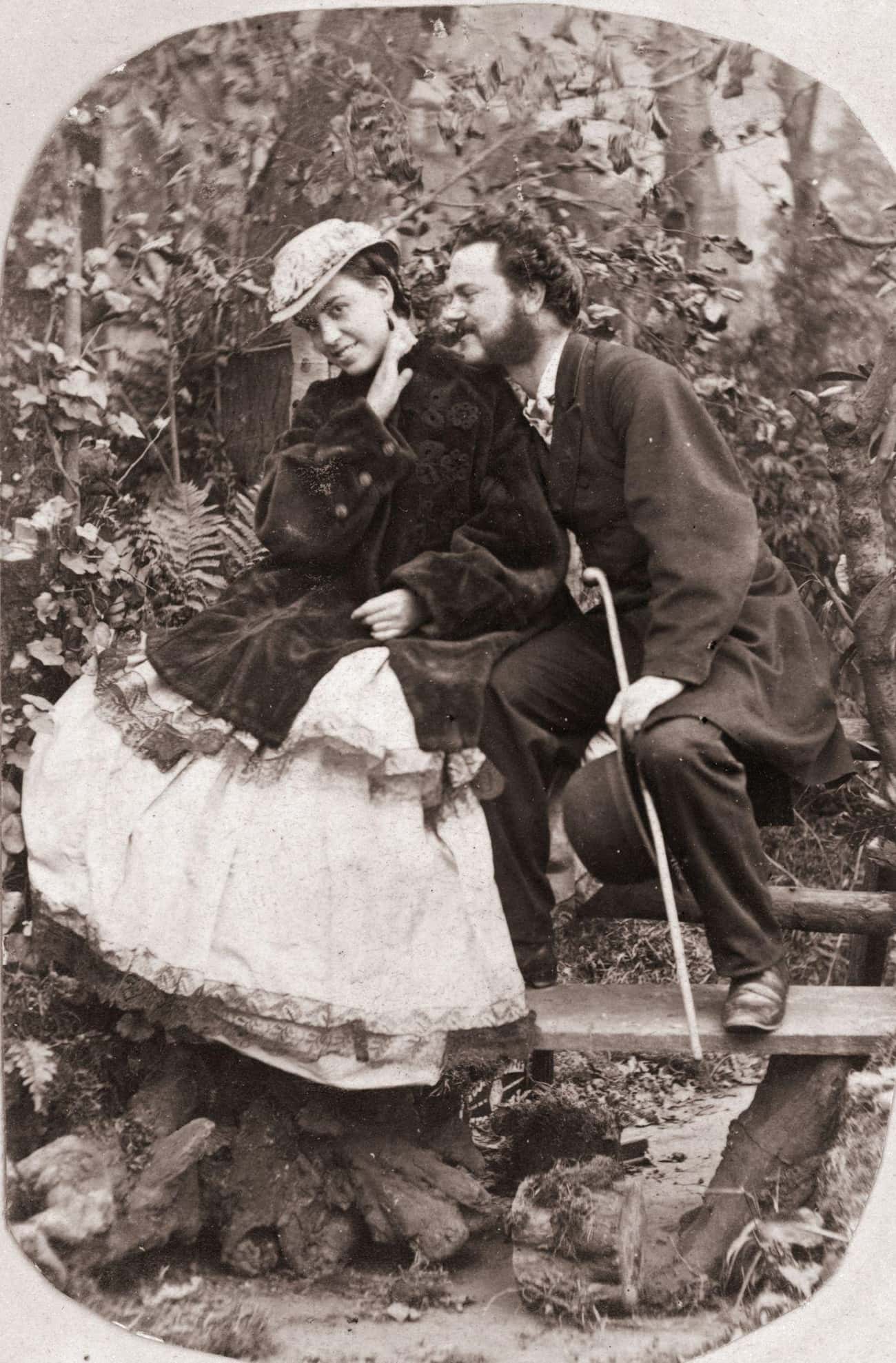 Man Whispers In His Sweetheart's Ear On A Country Walk, Date Unknown 