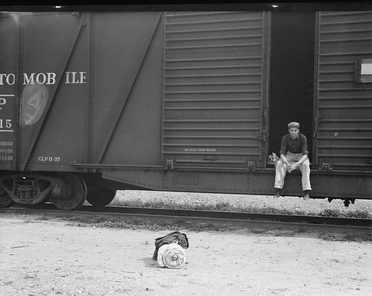 Itinerant Worker Waiting On A Stationary Train In Imperial Valley, CA, 1939