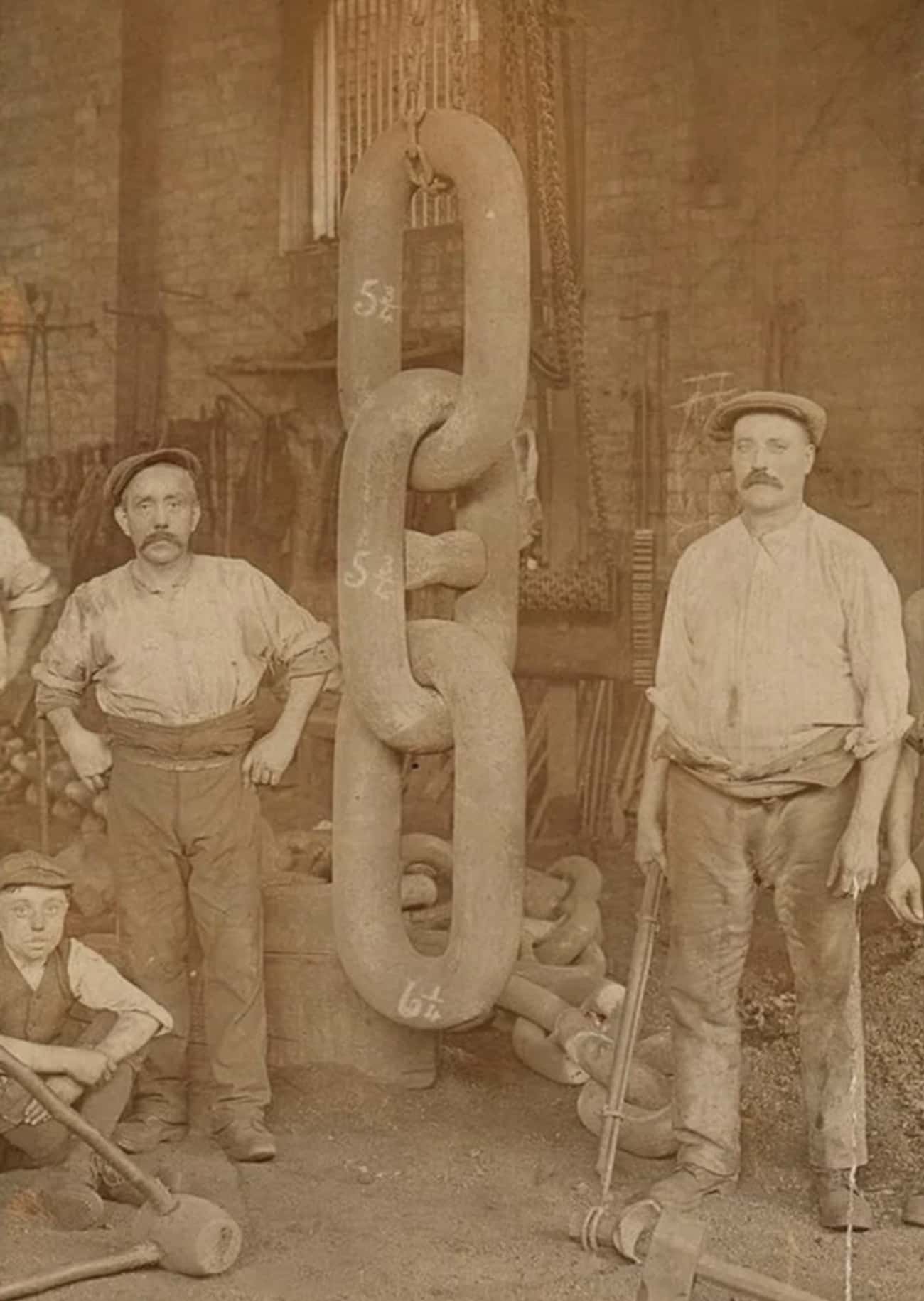 Workers Pose With The Ship's Anchor Chain
