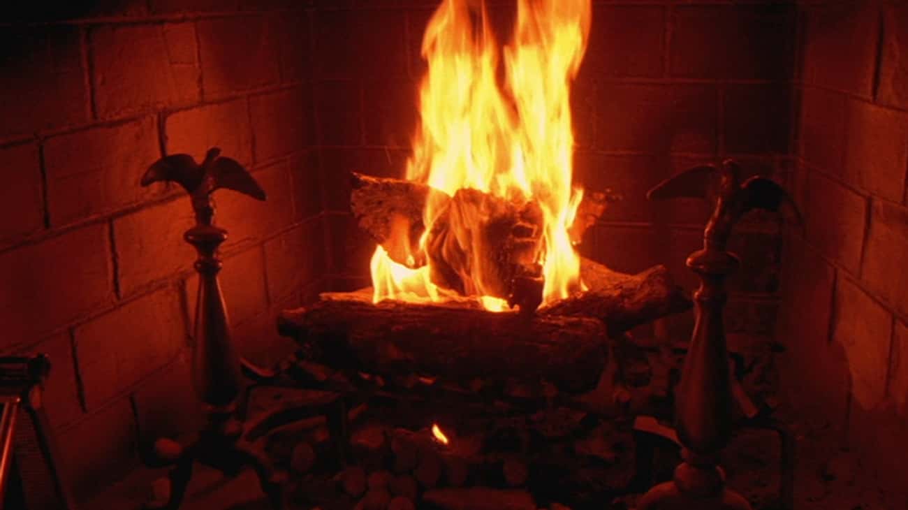 A Gremlin's Severed Head Burns In The Fireplace