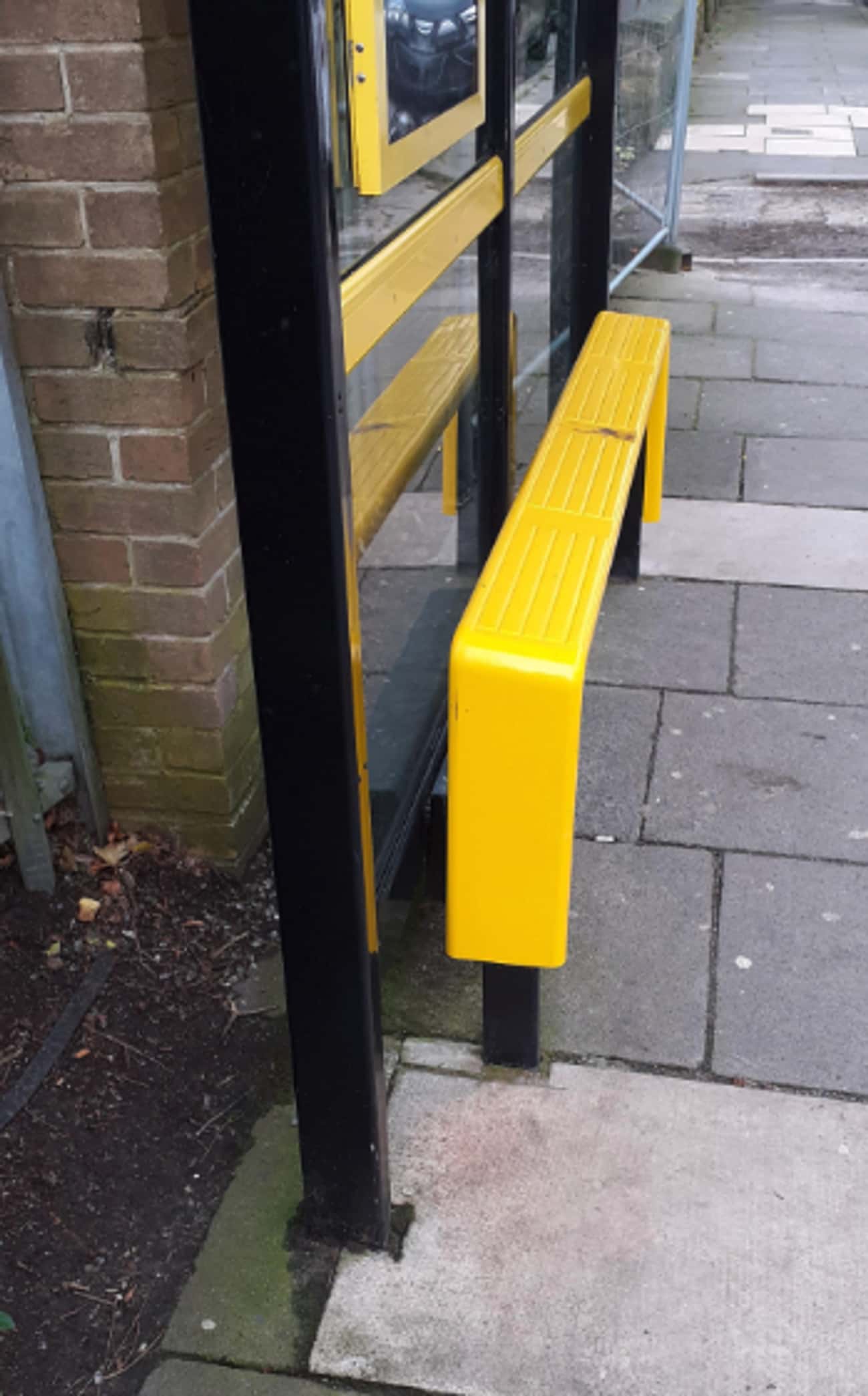 A Narrow And Slanted Bus Bench 