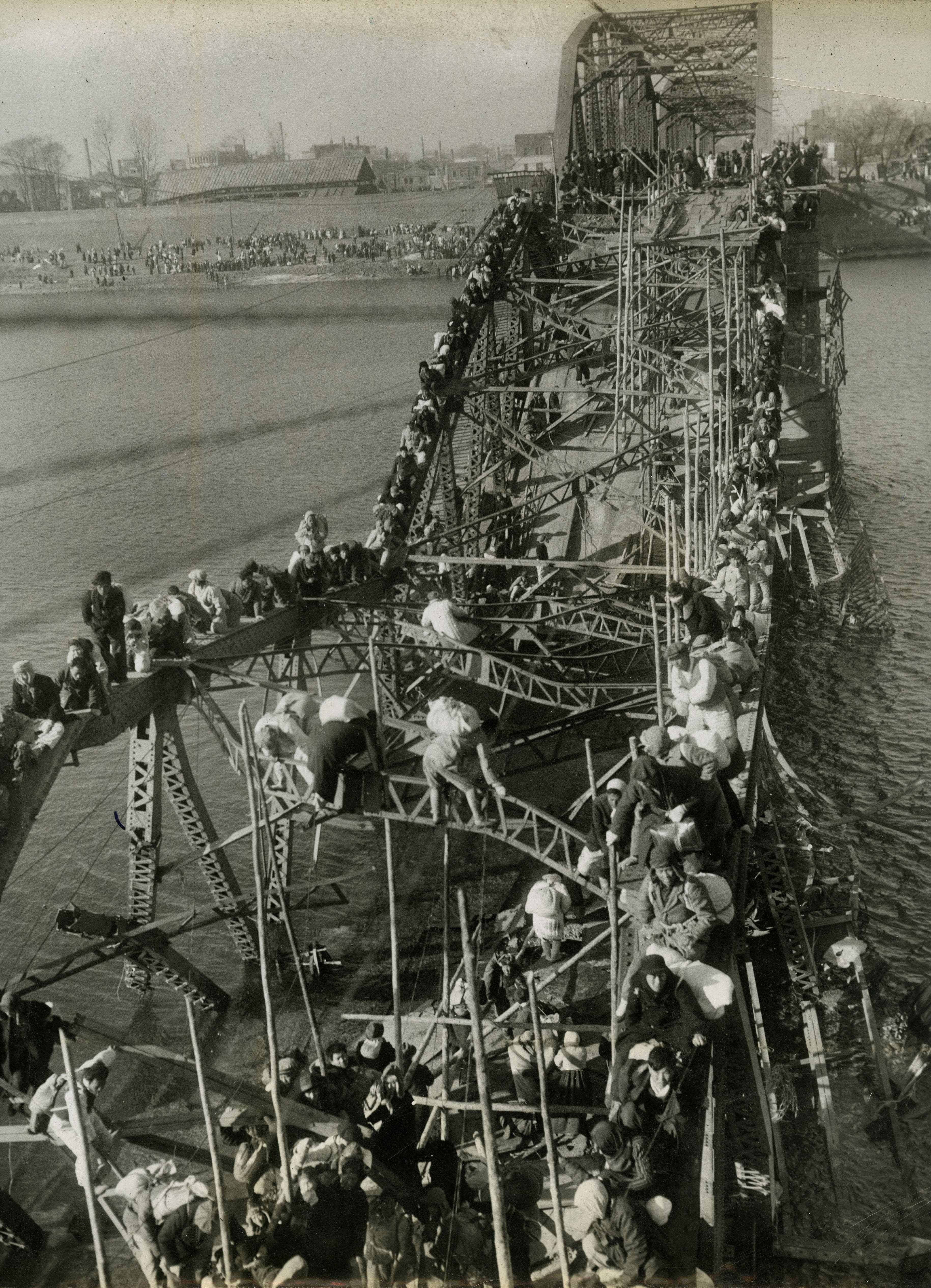 1951: 'Flight of Refugees Across Wrecked Bridge in Korea'