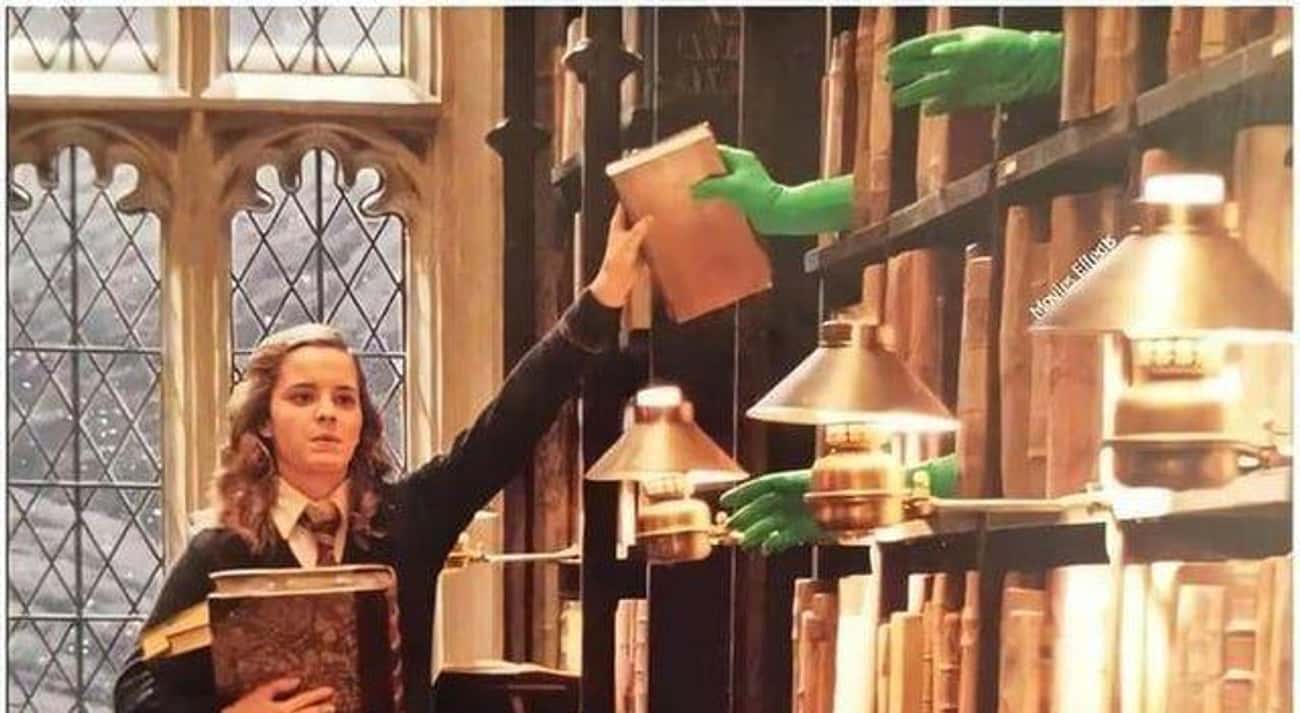 Real Hands Make Books Appear To Float Onto The Library Shelf