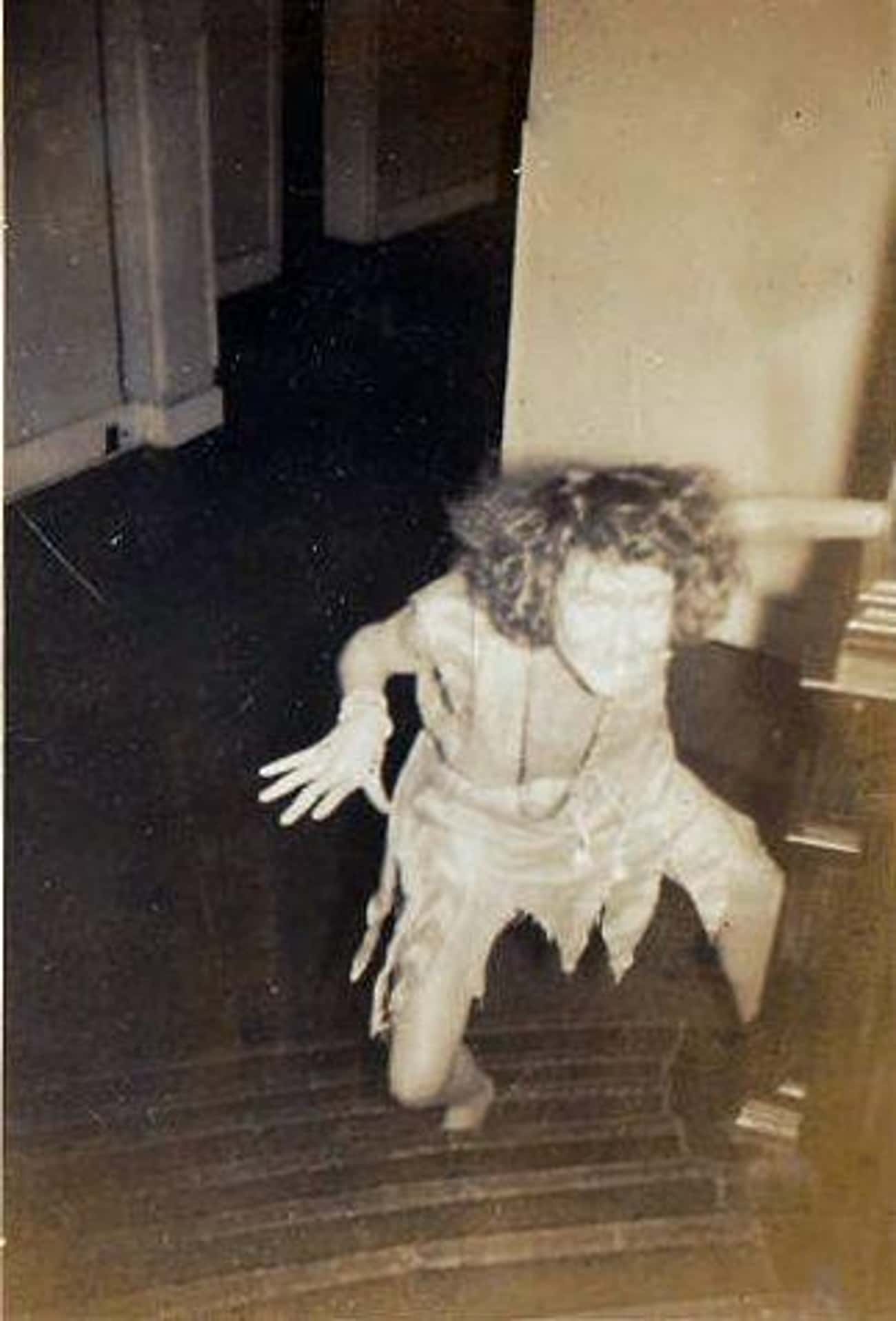 A Woman In Costume Creepily Climbing Stairs