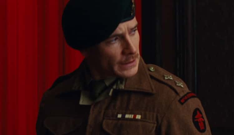 In Hacksaw Ridge (2016). After WWI veteran William Doss (Hugo Weaving) saw  Harold Doss in his new WWII uniform, his mouth starts shaking while putting  words together. This symptom is one of