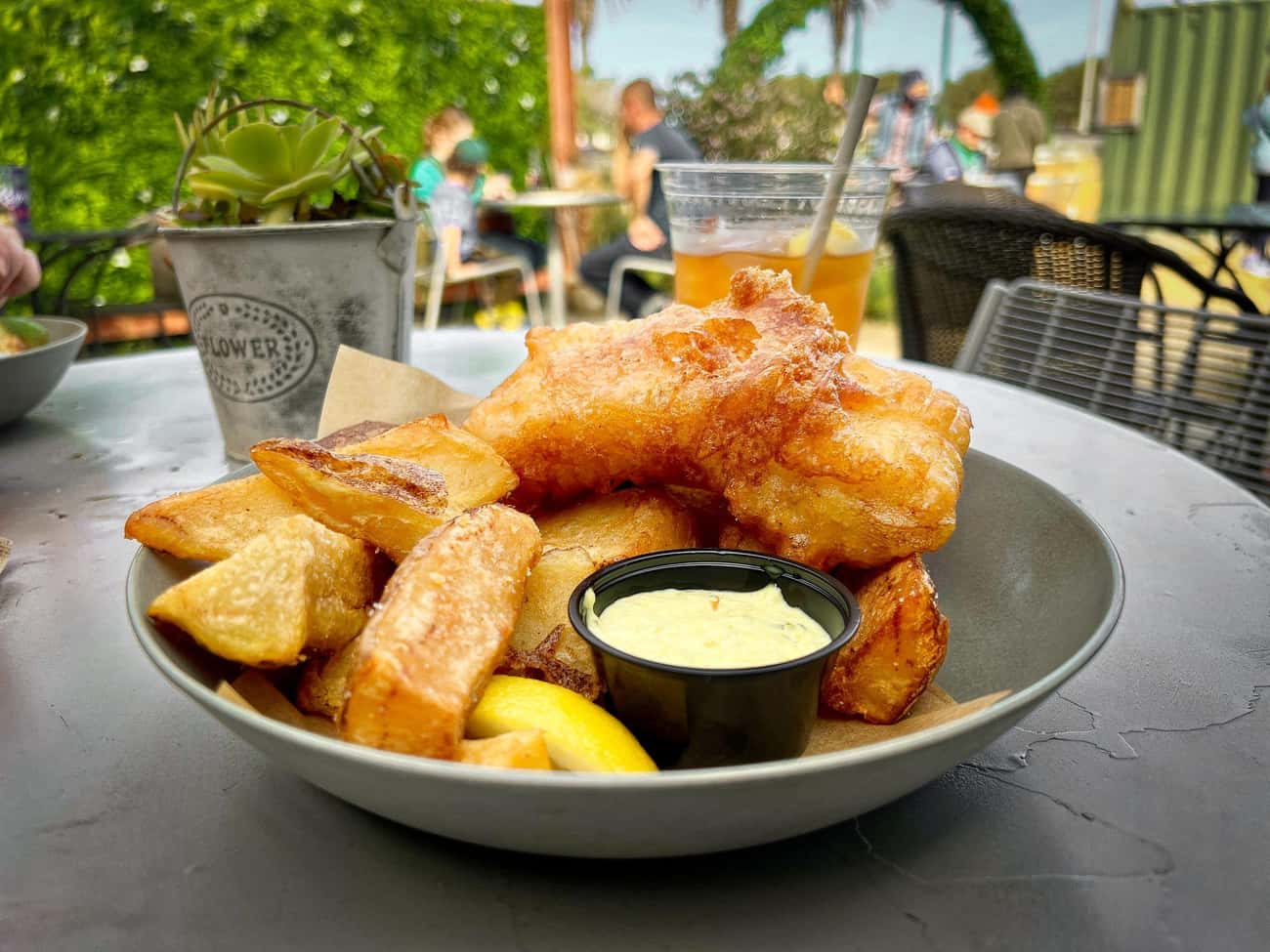 Fish And Chips Come With A Squeeze Of Lemon, Malt Vinegar, And Tartar Sauce